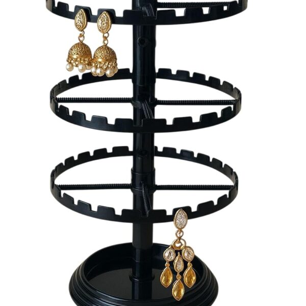 Black plastic 360-degree rotating 3-tier earring display stand with circular slotted rings for organizing and showcasing stud, hoop, hook, drop, and dangle earrings.